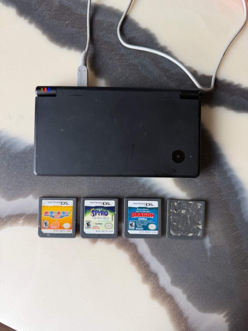 Black Nintendo DS with 4 DS Game Cartridges